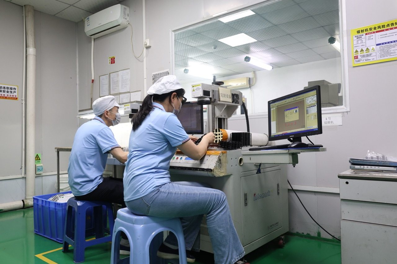 Technicians operating keypad inspection and test station