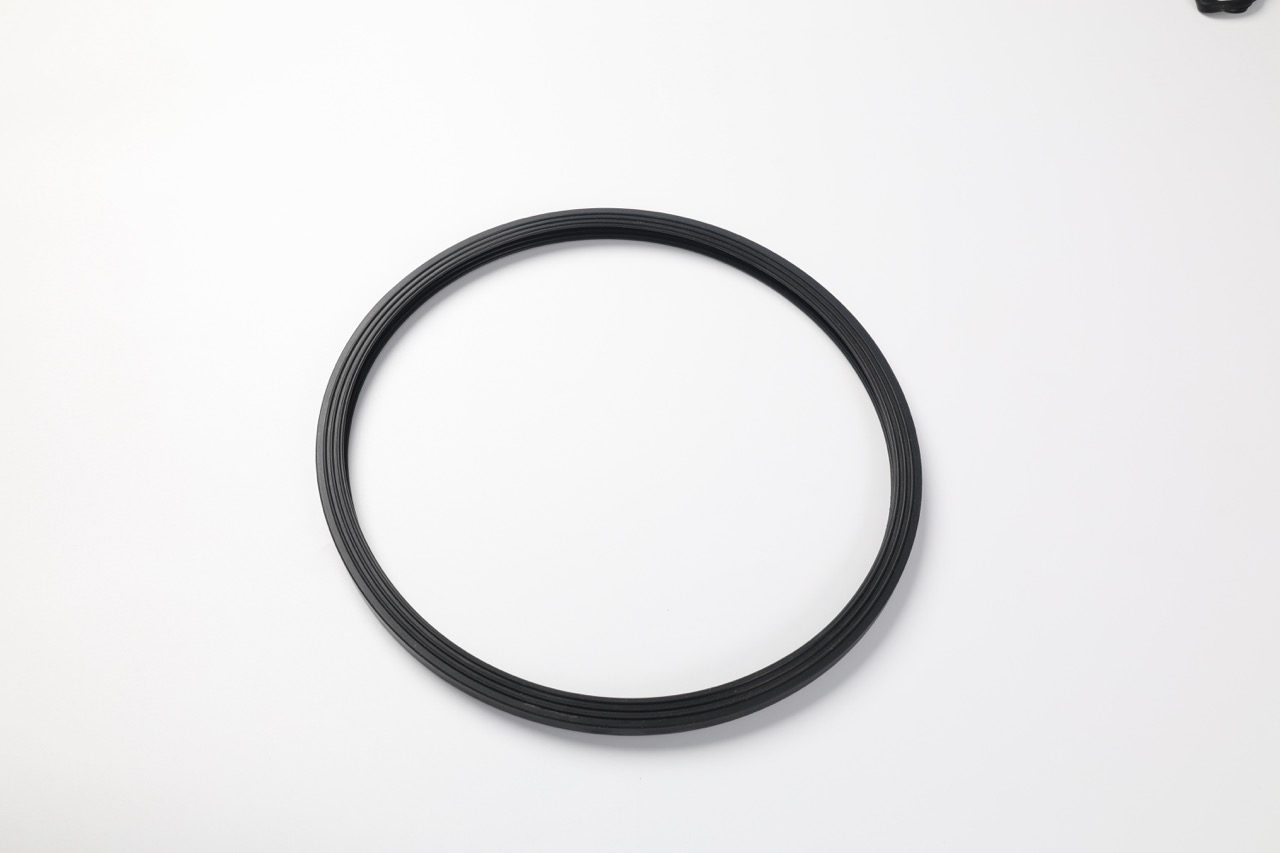 Black multi-ribbed silicone O-ring on white background